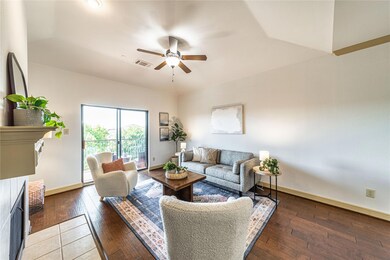 Living room featuring ceiling fan and hardwood / w