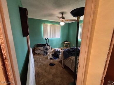 Carpeted bedroom with a textured ceiling and ceili