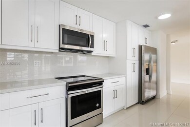Kitchen Whirlpool SS appliances, waterfall quartz 