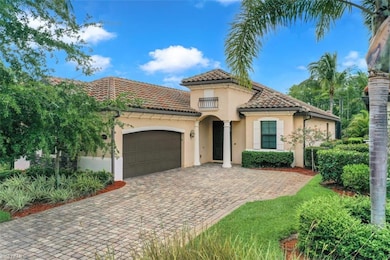 Mediterranean / spanish-style house with an attached garage, decorative driveway, stucco siding, and a tiled roof