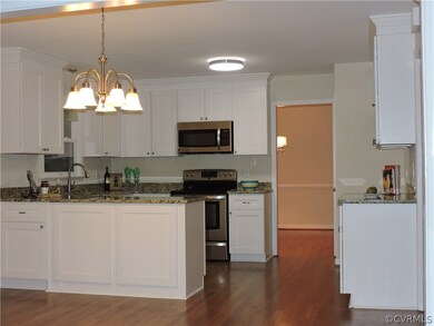 Kitchen boasts brand new cabinets, granite and lig