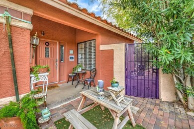 Property entrance with stucco siding, a gate, and a tiled roof