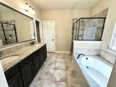 Bathroom featuring double vanity, separate shower and tub, and tile patterned floors