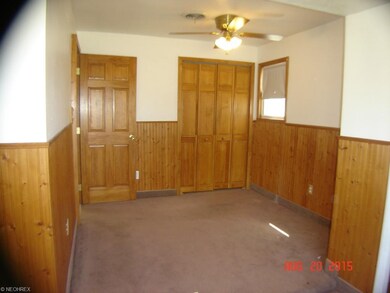 Large bedroom has ceiling fan, and two closets.