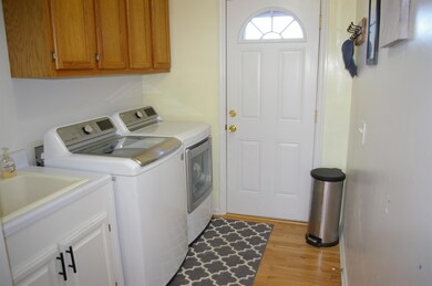 Large Utility Room with door going out onto the back deck