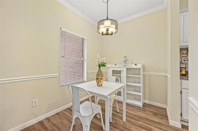 Dining room with baseboards, crown molding, a cha