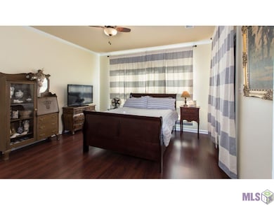 The curtains behind the bed open to 3 large window