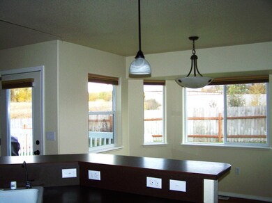Kitchen toward living room and yard