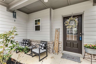 Charming covered front porch sets a warm and welco