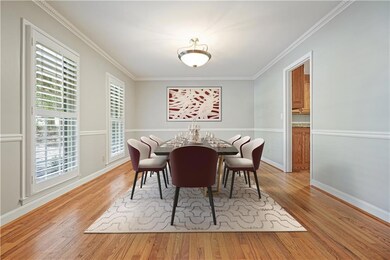 Dining area featuring crown molding and light wood-type flooring