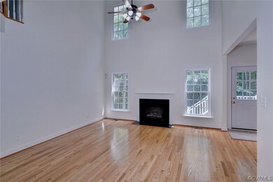 Hardwood floored living room with a fireplace and