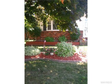 Exterior Front. A few mature trees help shade the 