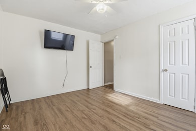unfurnished bedroom featuring wood finished floors and ceiling fan