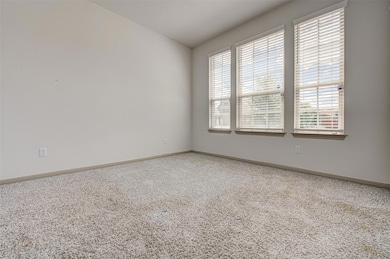 Carpeted empty room with baseboards and lofted ce