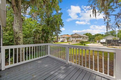 Wooden terrace with a residential view and a yard