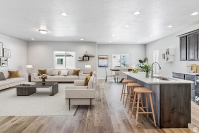 Living area featuring light wood finished floors, recessed lighting, and a textured ceiling