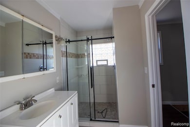 Full bath featuring vanity, a shower stall, and light tile patterned flooring