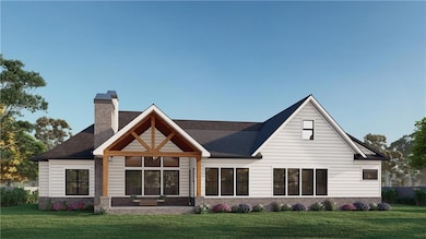Rear view of property with a lawn, brick siding, and a chimney