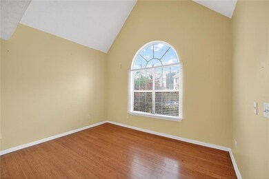 Unfurnished room featuring vaulted ceiling and wood-type flooring