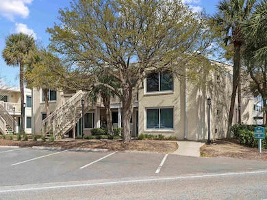 View of property featuring uncovered parking and s