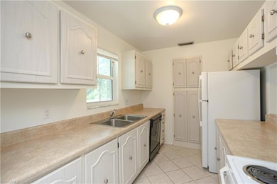 Kitchen with light tile patterned flooring, sink, 