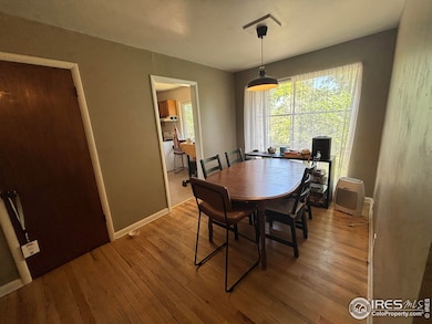 Dining room with hardwood flooring and view to the back yard.