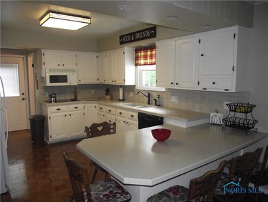 Remodeled kitchen with snack bar & stools, corian
