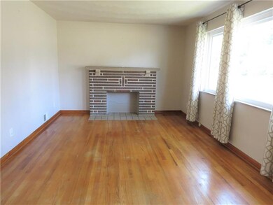 The living room is generous and is bathed in light with the large window.  The fireplace adds to the charm of this home.