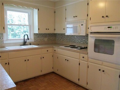Kitchen has updated hardware and tile backspash.