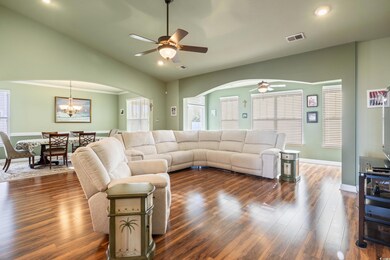 Living room with dark wood-type flooring and ceili
