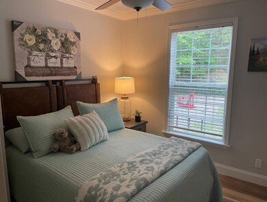 Bedroom featuring ornamental molding, wood finishe