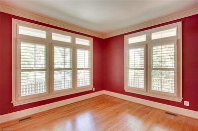 Formal living area with large windows to bring in the light from the wraparound porch.