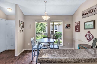 Dining room featuring baseboards, a textured ceili