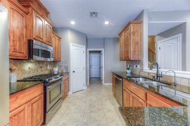 spacious kitchen with beautiful cabinetry, granite