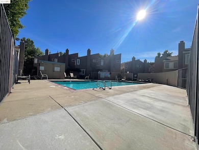 Community pool featuring a patio and a residential view