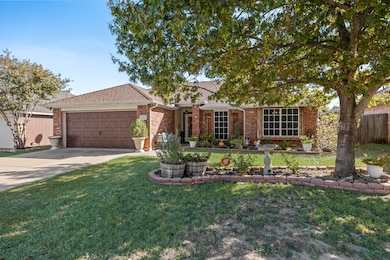 Ranch-style home featuring brick siding, concrete driveway, a garage, and a shingled roof