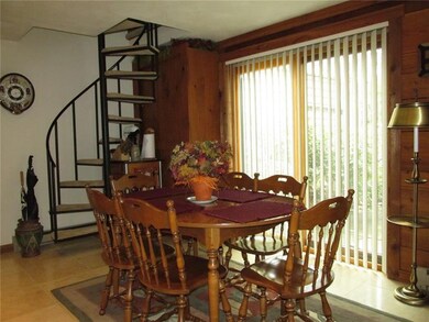 Behind the circular staircase is a built in pantry