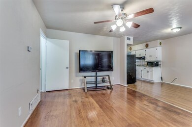 Unfurnished living room featuring ceiling fan and 