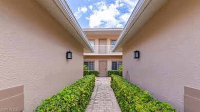 View of exterior entry with stucco siding and a ba