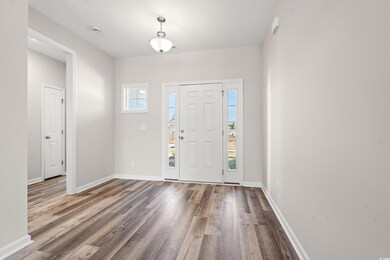 Entryway with wood finished floors and baseboards