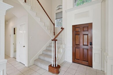Tiled two story entryway with lots of natural ligh