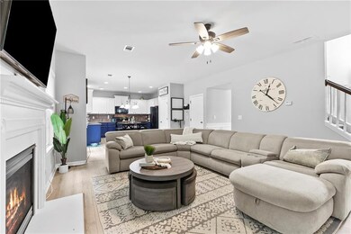 Living area with a ceiling fan, visible vents, a w