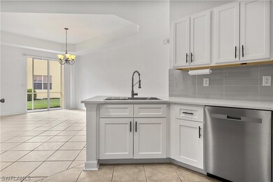 Kitchen featuring backsplash, hanging light fixtur