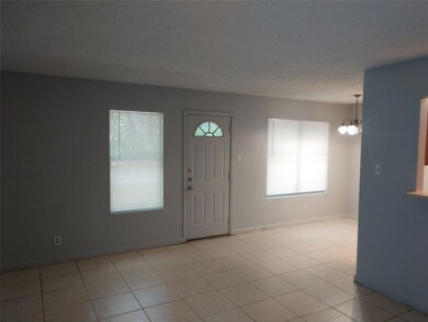 Entryway featuring a chandelier and light tile pa