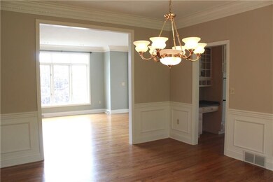 The wood floors continue into the living room from