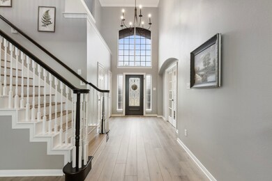 This spacious entryway features a high ceiling wit
