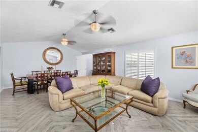 Living room featuring ceiling fan, light parquet f