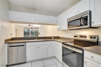 Kitchen featuring light tile patterned floors, whi