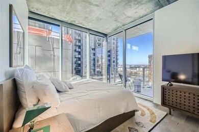 Bedroom featuring floor to ceiling windows and ac