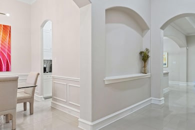 Corridor with ornamental molding and light tile pa